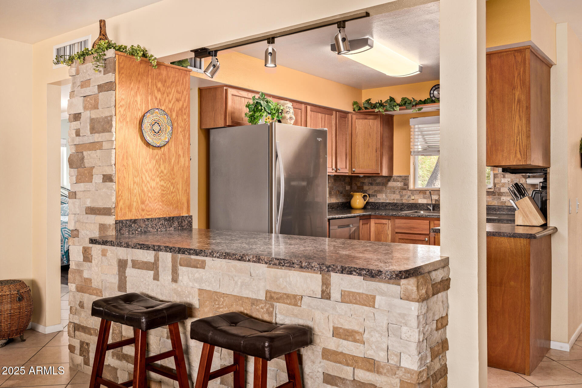 5501 East Adobe Road Mesa, AZ 85205 - Photo 11 of 38 a kitchen with stainless steel appliances granite countertop a sink and refrigerator