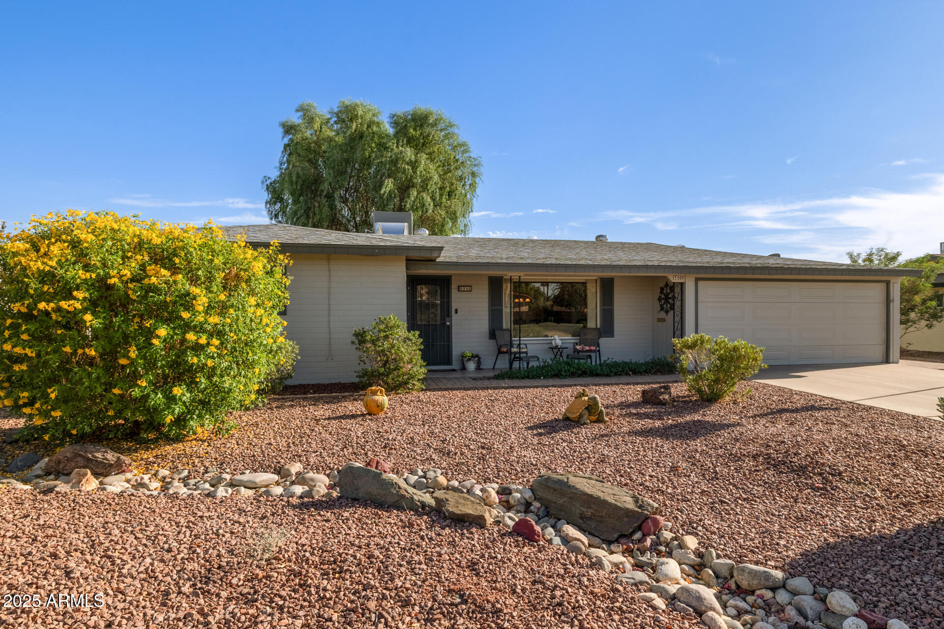 5501 East Adobe Road Mesa, AZ 85205 - Photo 2 of 38 a front view of a house with a garden