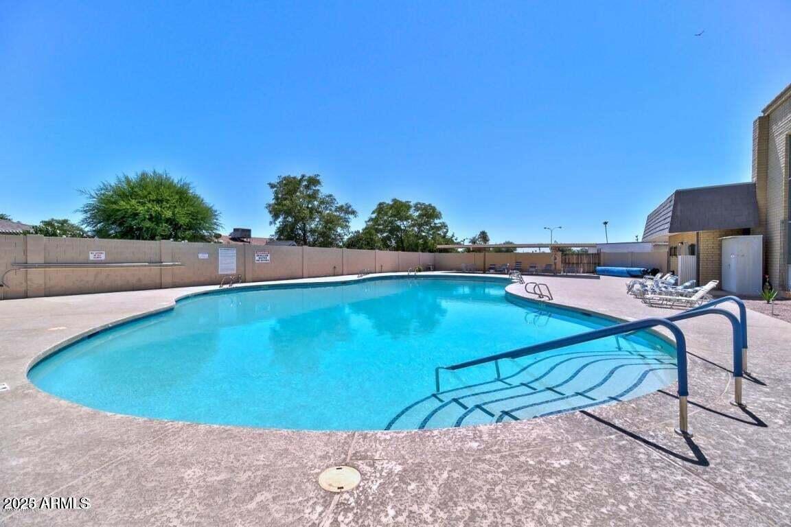 5501 East Adobe Road Mesa, AZ 85205 - Photo 31 of 38 a view of a swimming pool with an outdoor seating and a potted plant