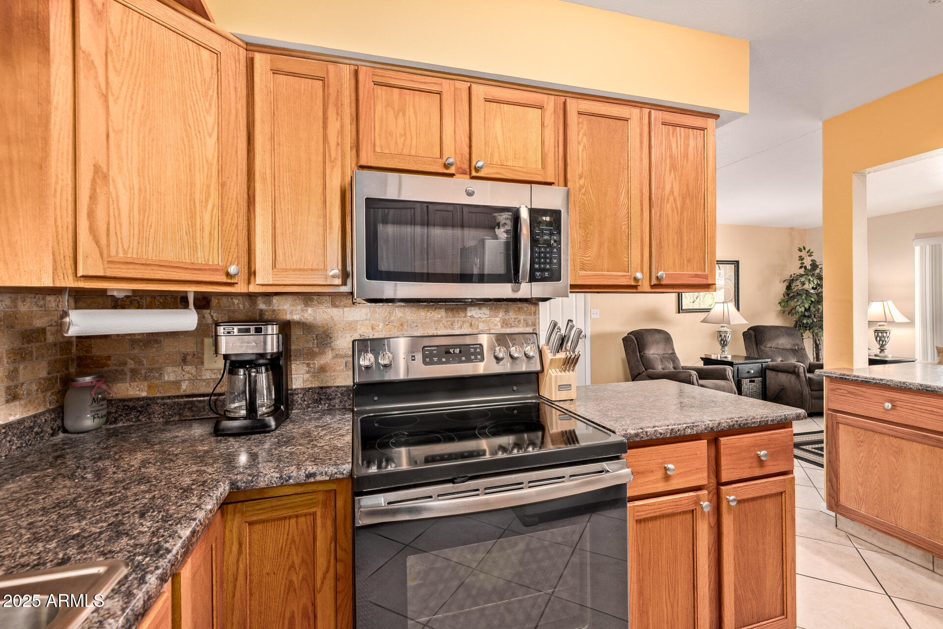 5501 East Adobe Road Mesa, AZ 85205 - Photo 8 of 38 a kitchen with stainless steel appliances granite countertop a stove a sink and a microwave