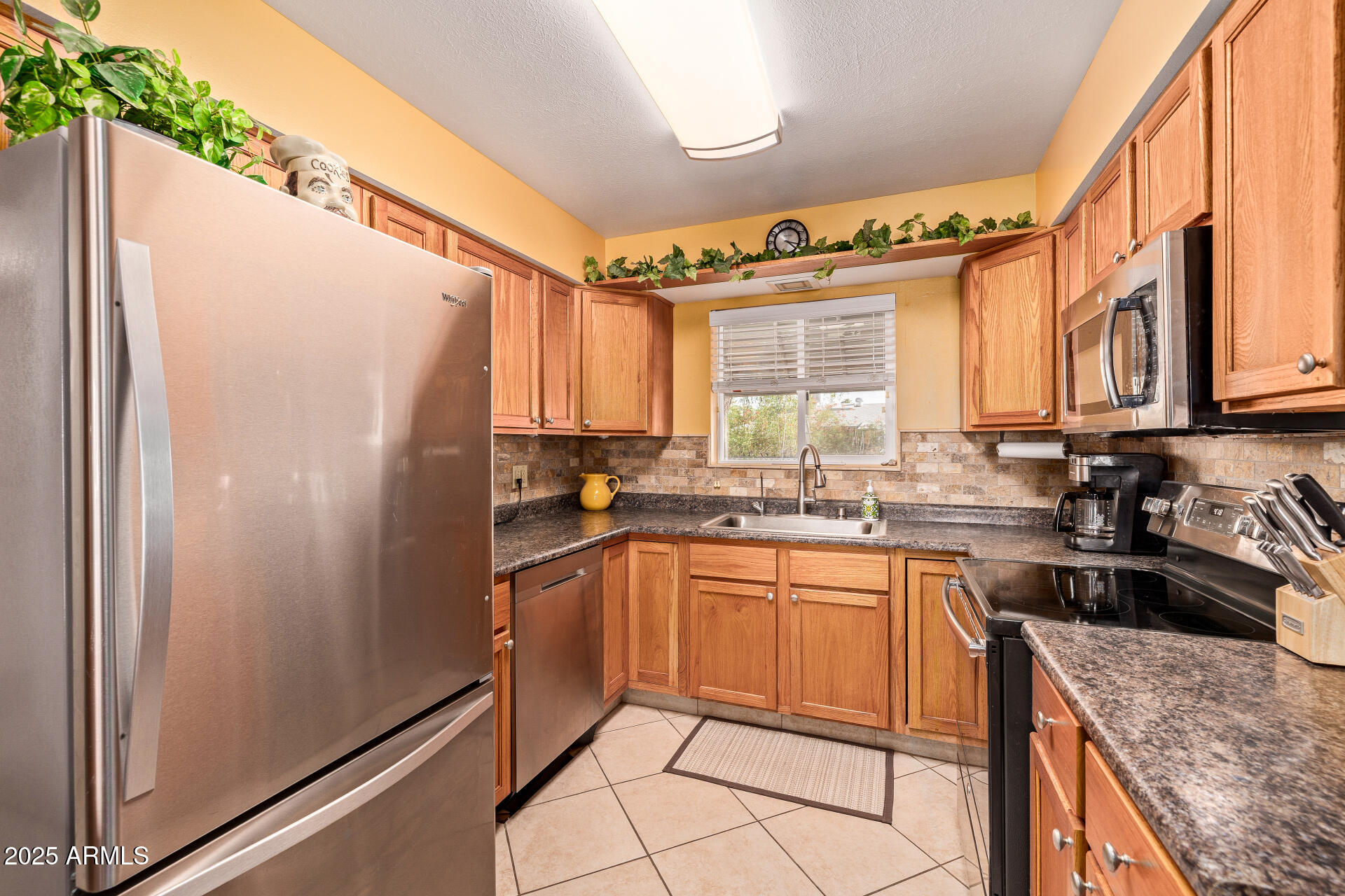 5501 East Adobe Road Mesa, AZ 85205 - Photo 9 of 38 a kitchen with granite countertop a refrigerator and a sink