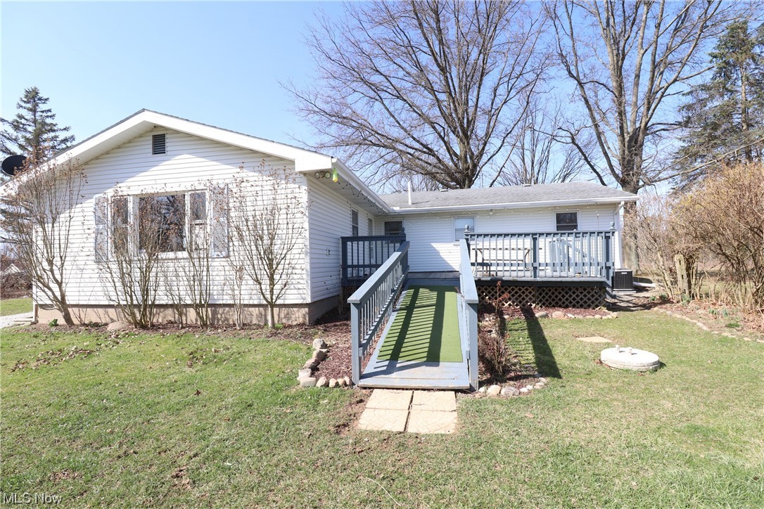 7879 Beach Road Wadsworth, OH 44281 - Photo 23 of 27 Rear view of property with a wooden deck and a lawn