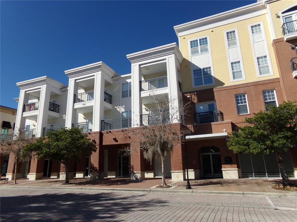 a front view of a building and car parked