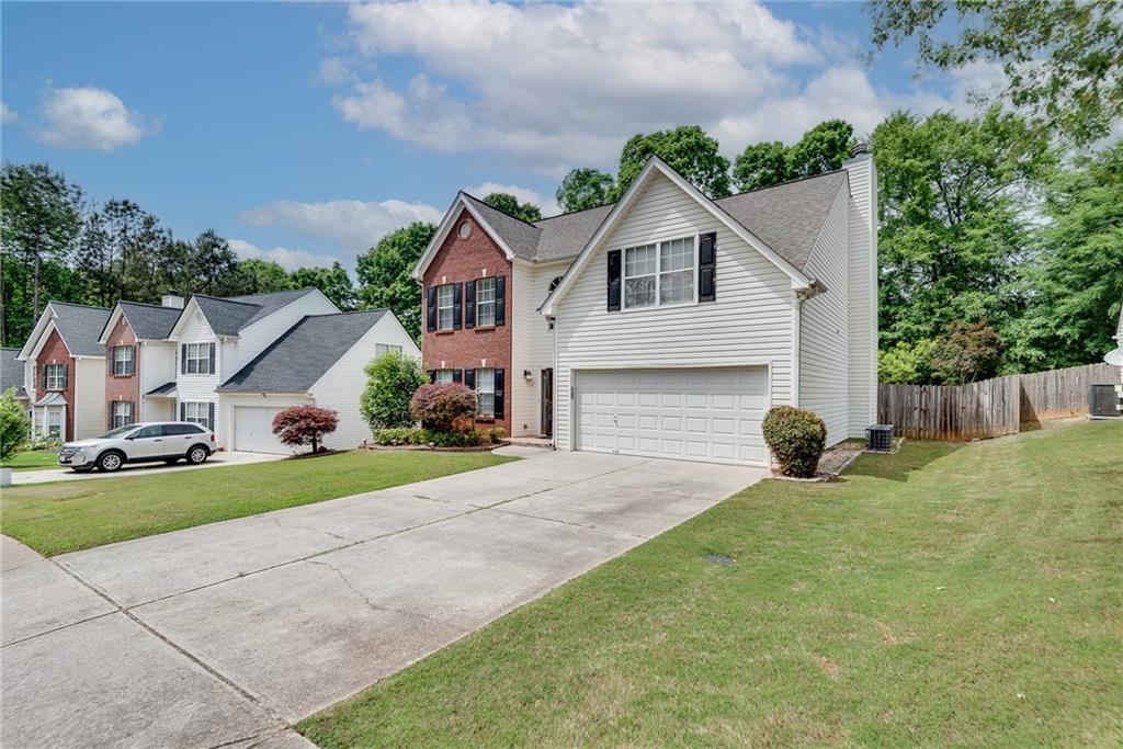 3337 Baymount Way Lawrenceville, GA 30043 - Photo 5 of 47 a front view of a house with a yard and garage