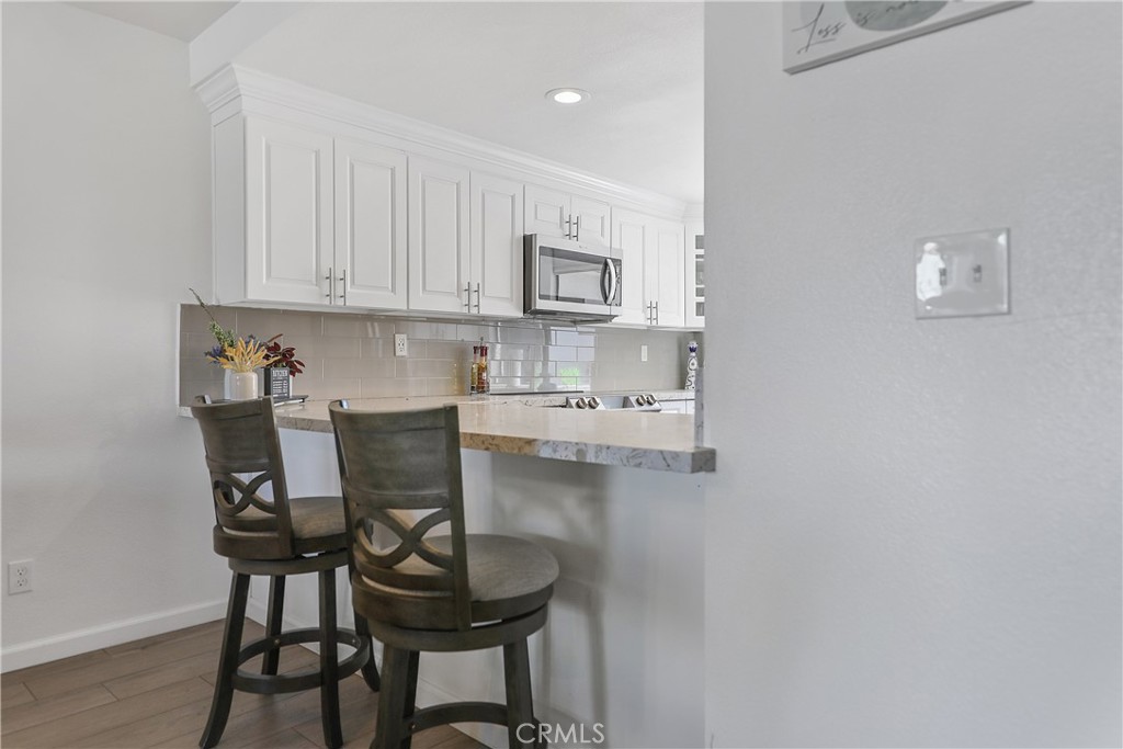 74 Avenida Las Palmas Rancho Mirage, CA 92270 - Photo 6 of 23 a view of a dining room with furniture and wooden floor