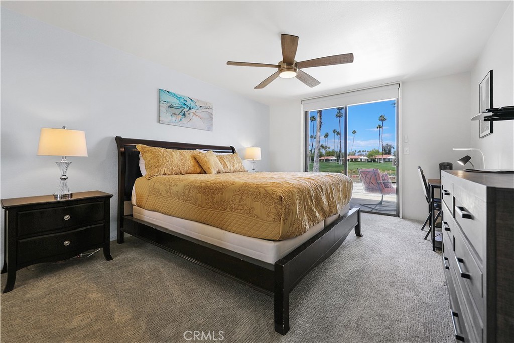74 Avenida Las Palmas Rancho Mirage, CA 92270 - Photo 10 of 23 a bedroom with a bed and a chandelier
