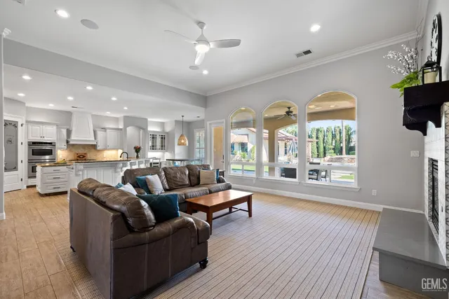 a large kitchen with kitchen island a sink a center island stainless steel appliances and a cabinets