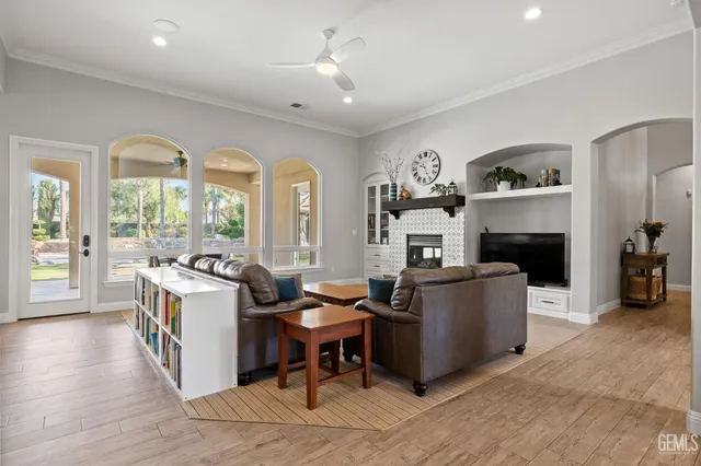 a large kitchen with stainless steel appliances lots of counter space and windows