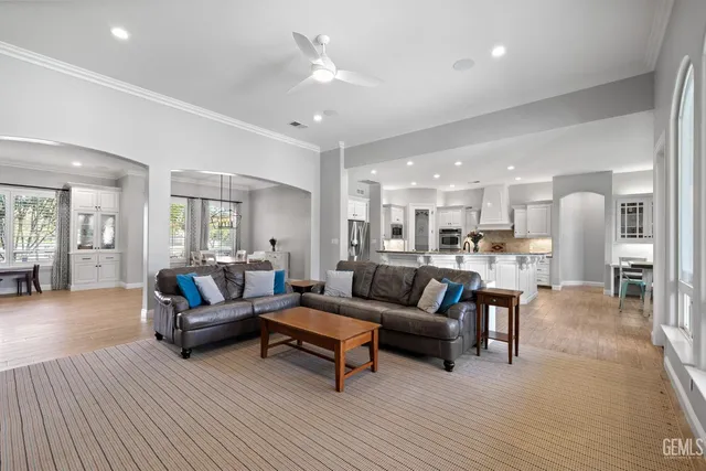 a large kitchen with granite countertop a large counter top space appliances and cabinets