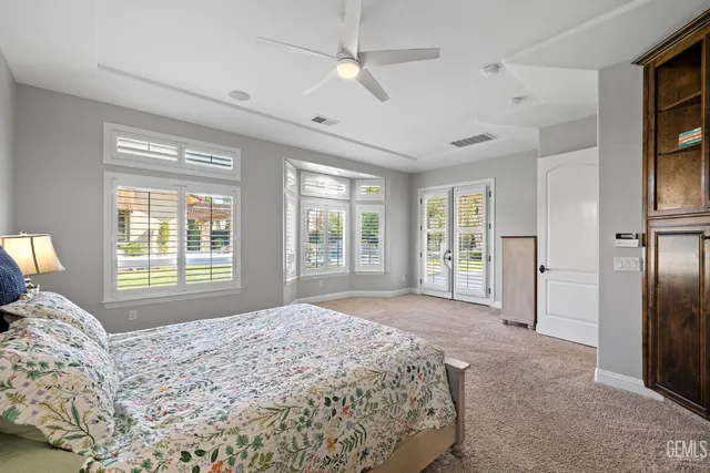 a bathroom with a glass shower door and a window
