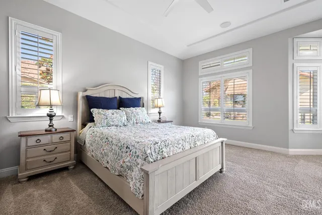 a bathroom with a granite countertop sink a toilet and a mirror