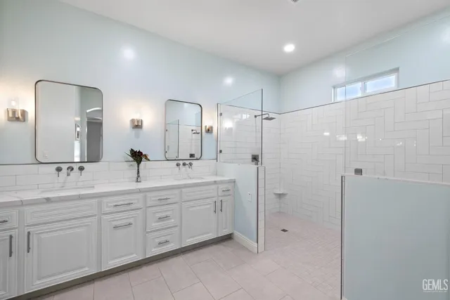 a view of a house with a big yard potted plants and palm trees
