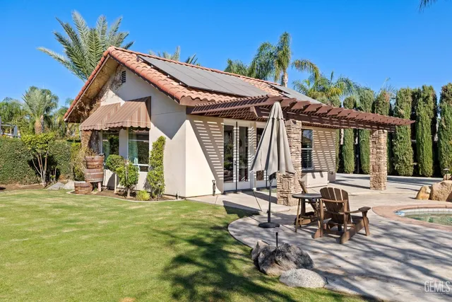 a view of a chairs and table in backyard of the house