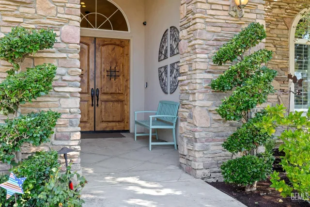 a dining room with wooden floor a chandelier a wooden table and chairs