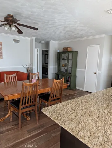 a living room with dining room and wooden floor