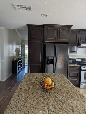 a kitchen with kitchen island a counter top space cabinets and appliances