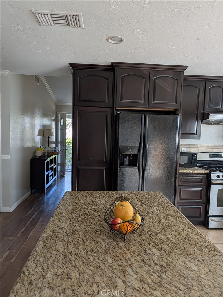 8394 Comet Street Rancho Cucamonga, CA 91730 - Photo 18 of 39 a kitchen with kitchen island a counter top space cabinets and appliances