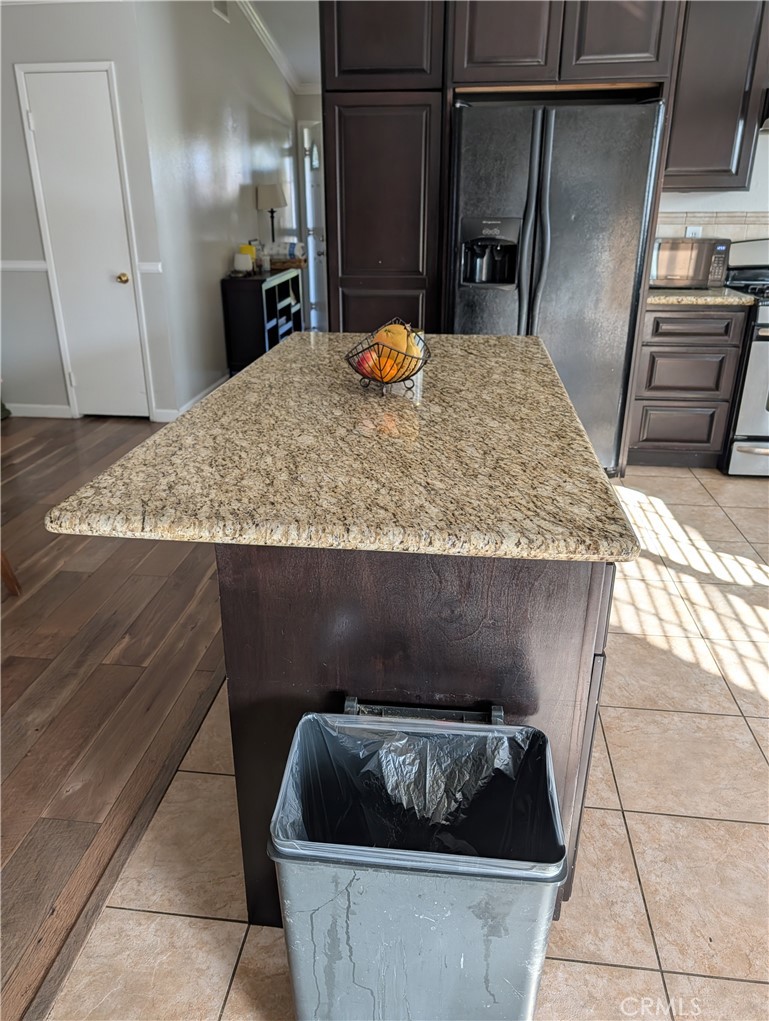 8394 Comet Street Rancho Cucamonga, CA 91730 - Photo 21 of 39 a kitchen with granite countertop sink and refrigerator
