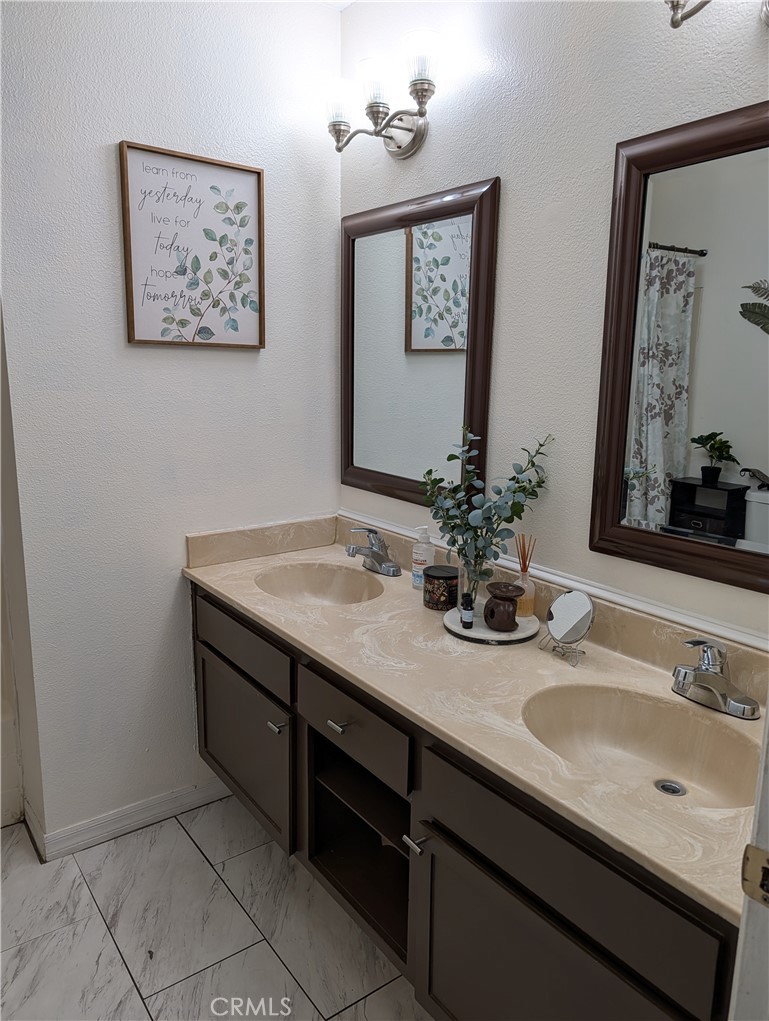 8394 Comet Street Rancho Cucamonga, CA 91730 - Photo 25 of 39 a bathroom with a sink and a mirror