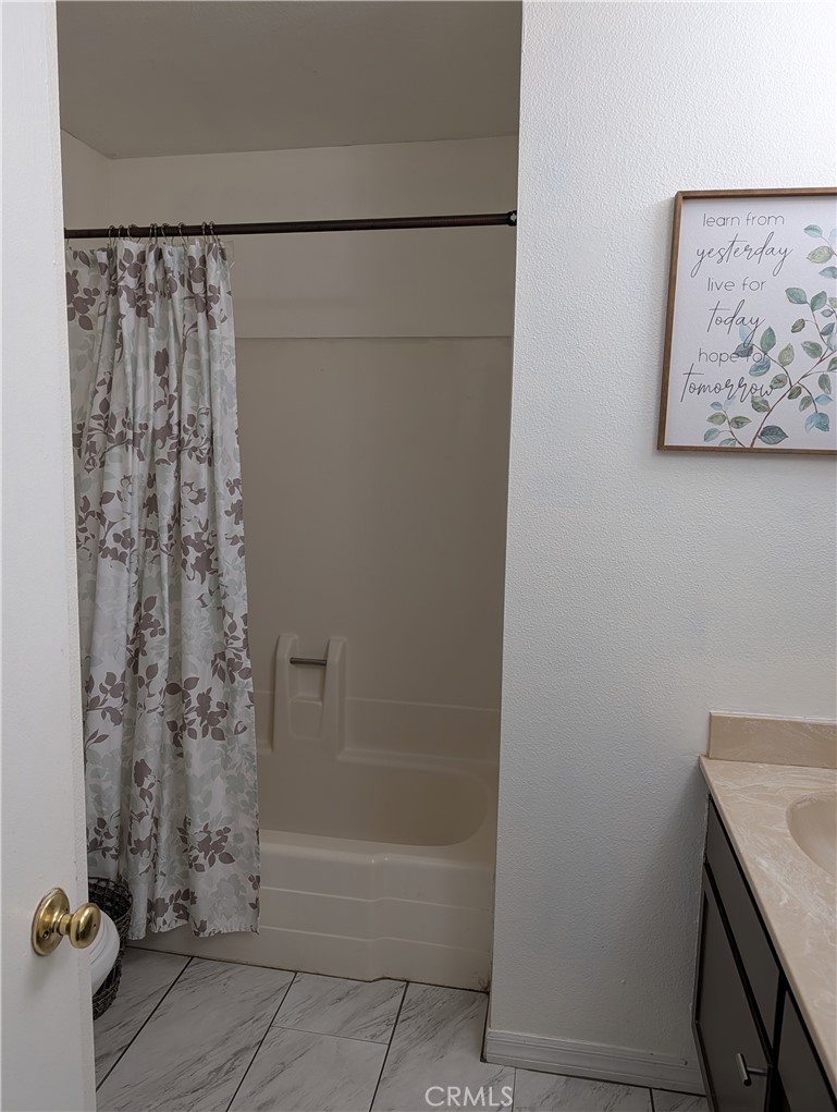 8394 Comet Street Rancho Cucamonga, CA 91730 - Photo 28 of 39 a bathroom with a shower and a sink