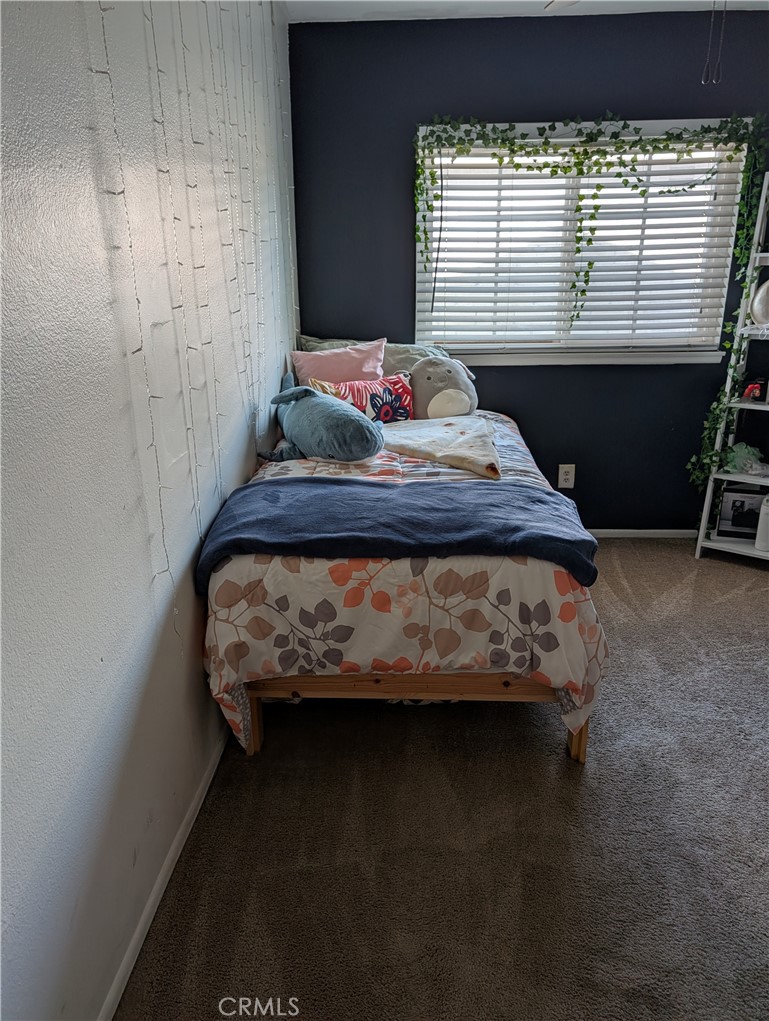 8394 Comet Street Rancho Cucamonga, CA 91730 - Photo 29 of 39 a bed sitting in a bedroom next to a window
