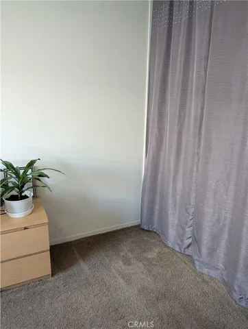 a view of a room with a sink and a mirror
