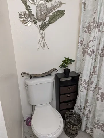 a bathroom with a toilet and a mirror