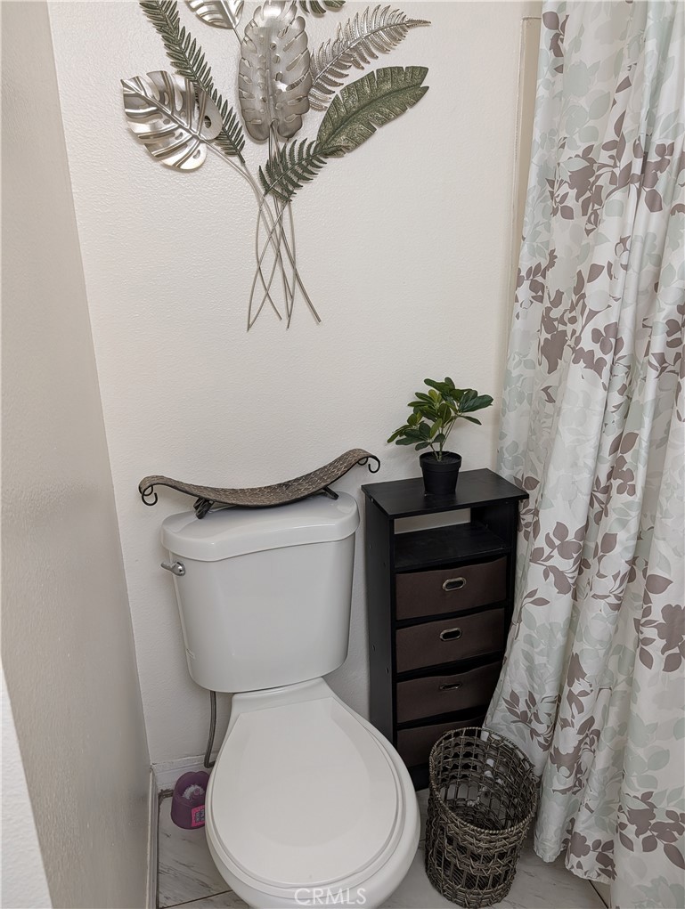 8394 Comet Street Rancho Cucamonga, CA 91730 - Photo 31 of 39 a bathroom with a toilet and a mirror