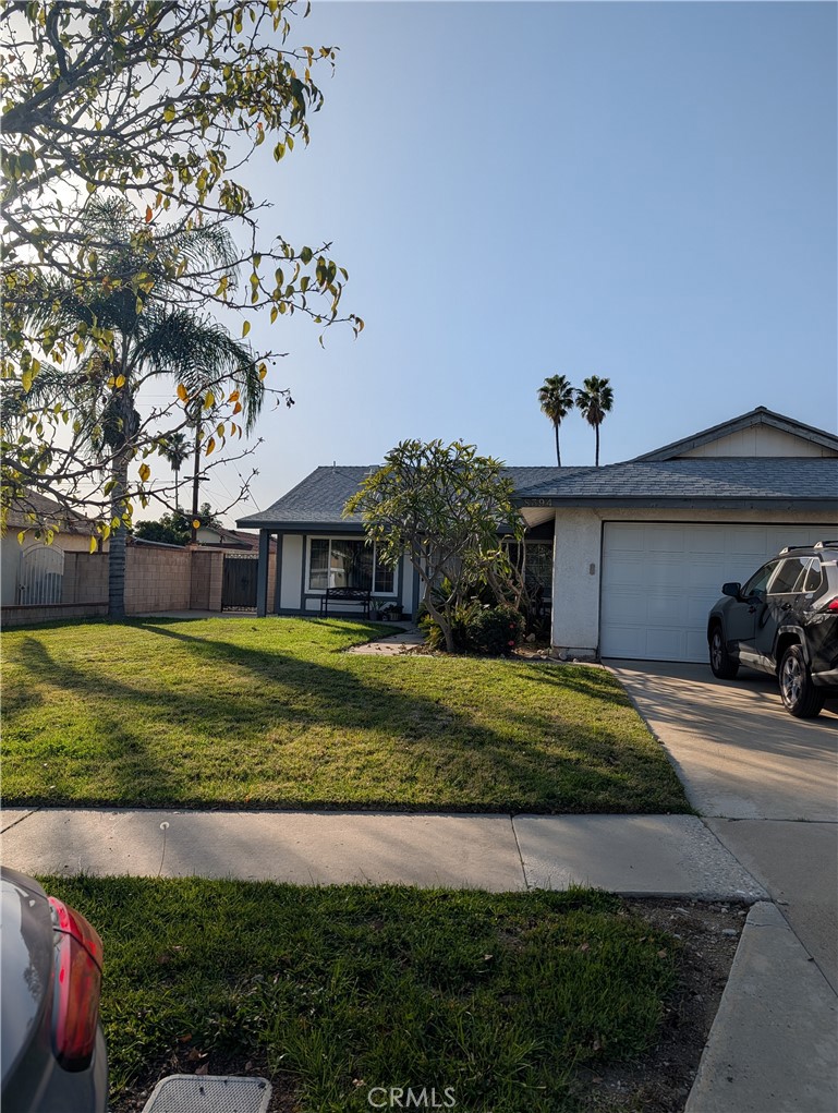 8394 Comet Street Rancho Cucamonga, CA 91730 - Photo 5 of 39 a front view of a house with a yard