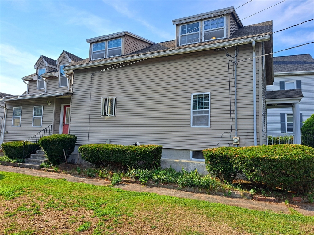 a view of a house with a yard and plants