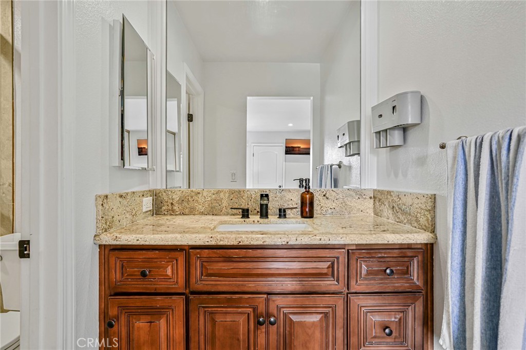 1642 Dalmatia Drive San Pedro, CA 90732 - Photo 17 of 26 a bathroom with a granite countertop sink and a mirror