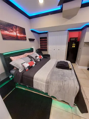 a bedroom with a bed and a dresser