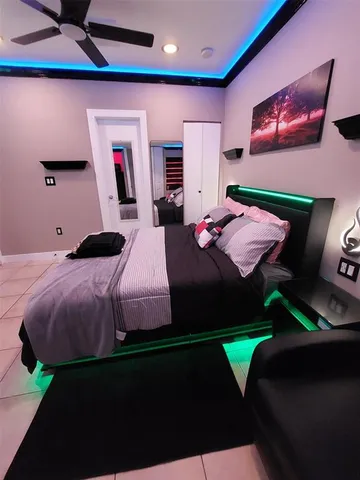 a bedroom with a bed and a mirror