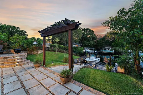 a view of a house with backyard and sitting area