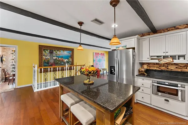 a spacious bedroom with a bed and a dresser