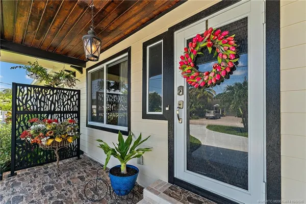 a open kitchen with stainless steel appliances granite countertop a stove and a white cabinets