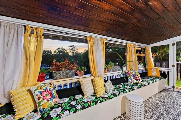 a view of pool with outdoor seating and plants