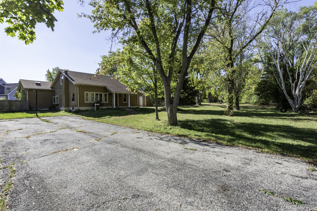 1700 Gideon Avenue Zion, IL 60099 - Photo 5 of 33 a view of a house with a big yard and large trees