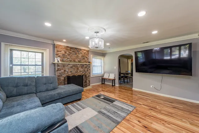a living room with furniture a fireplace and a flat screen tv