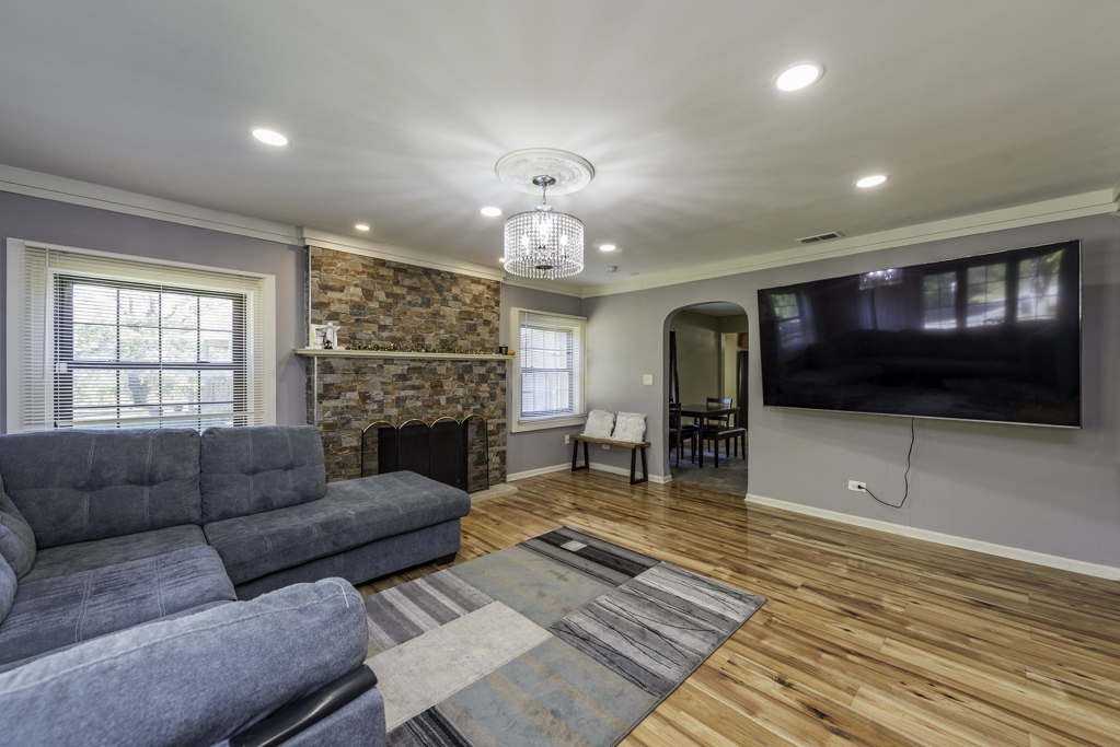 1700 Gideon Avenue Zion, IL 60099 - Photo 6 of 33 a living room with furniture a fireplace and a flat screen tv