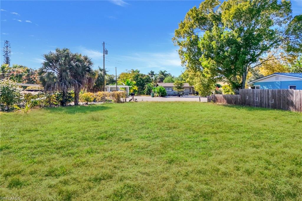 59 River Court Naples, FL 34110 - Photo 6 of 7 a view of a field of grass and trees