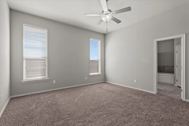 a spacious bathroom with a double vanity sink and a mirror
