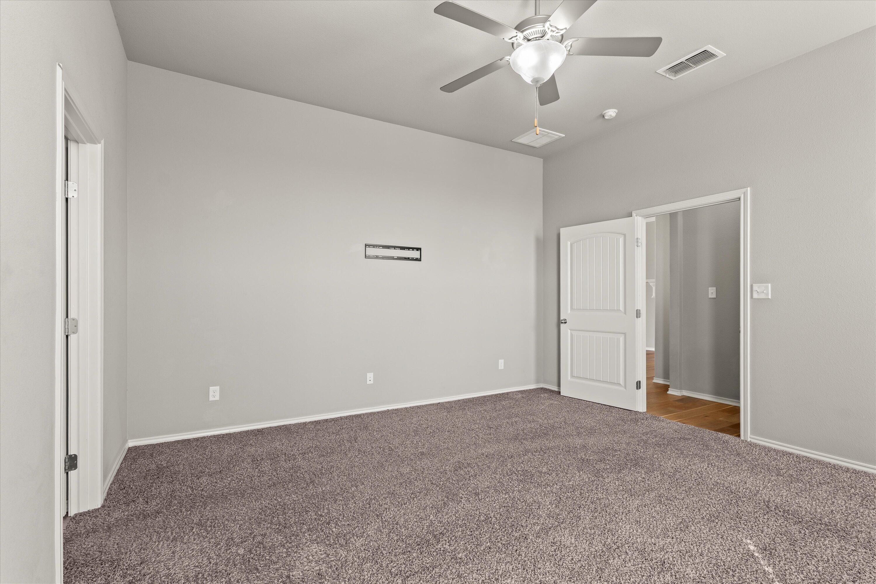 9616 Kline Avenue Lubbock, TX 79424 - Photo 16 of 33 a view of an empty room with a ceiling fan