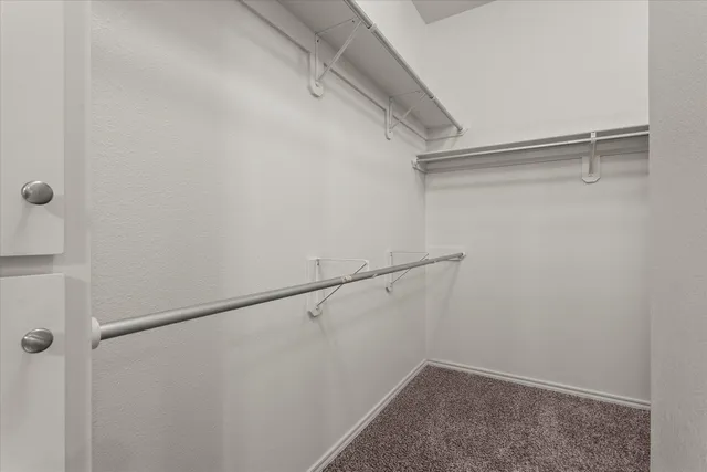 an empty room with a chandelier fan