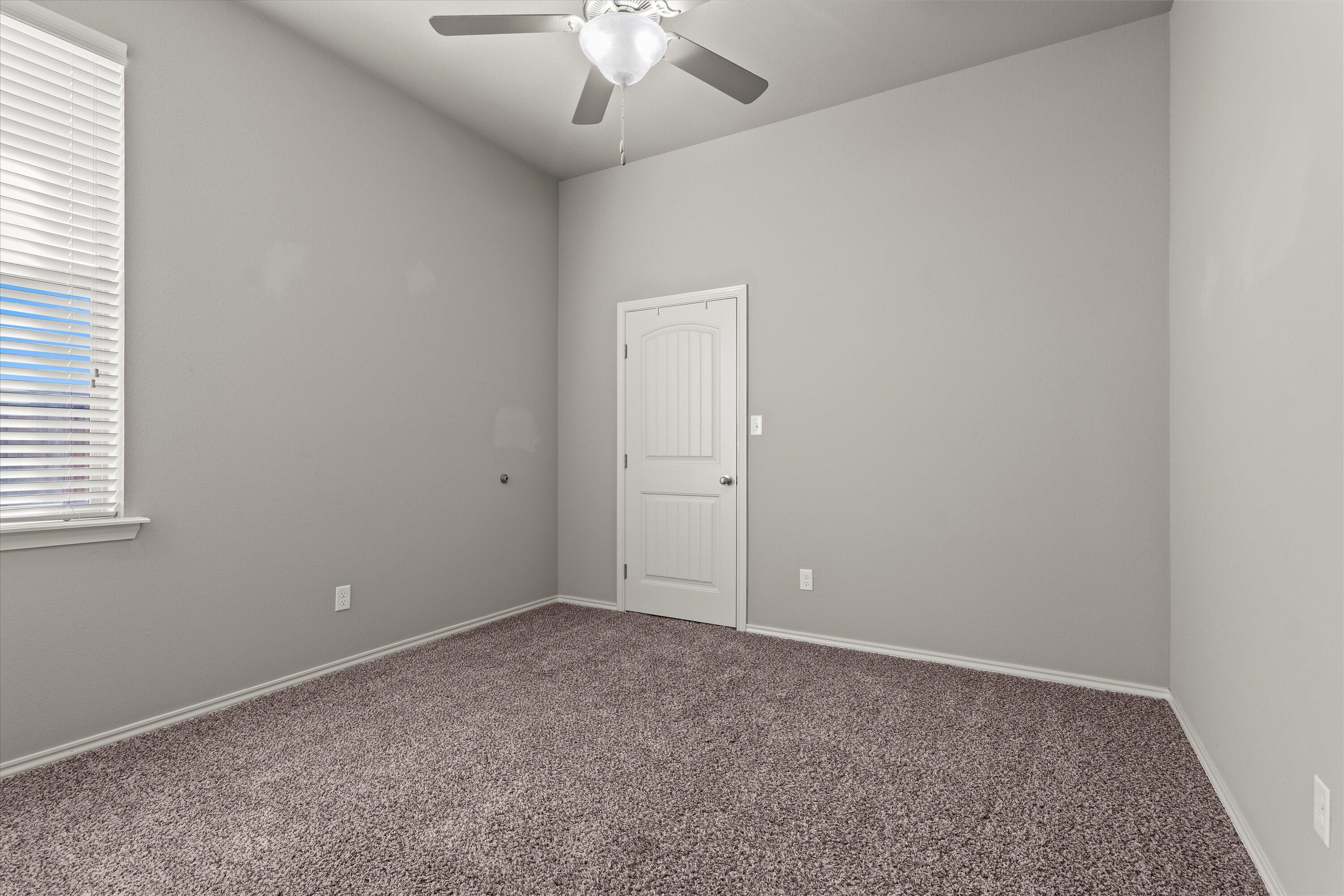 9616 Kline Avenue Lubbock, TX 79424 - Photo 22 of 33 an empty room with a chandelier fan