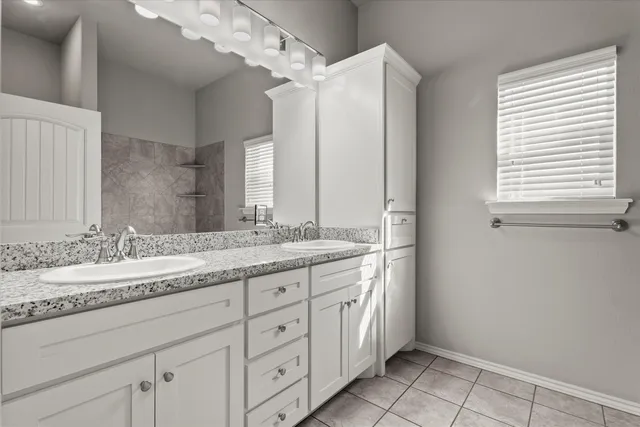 an empty room with a window and a ceiling fan