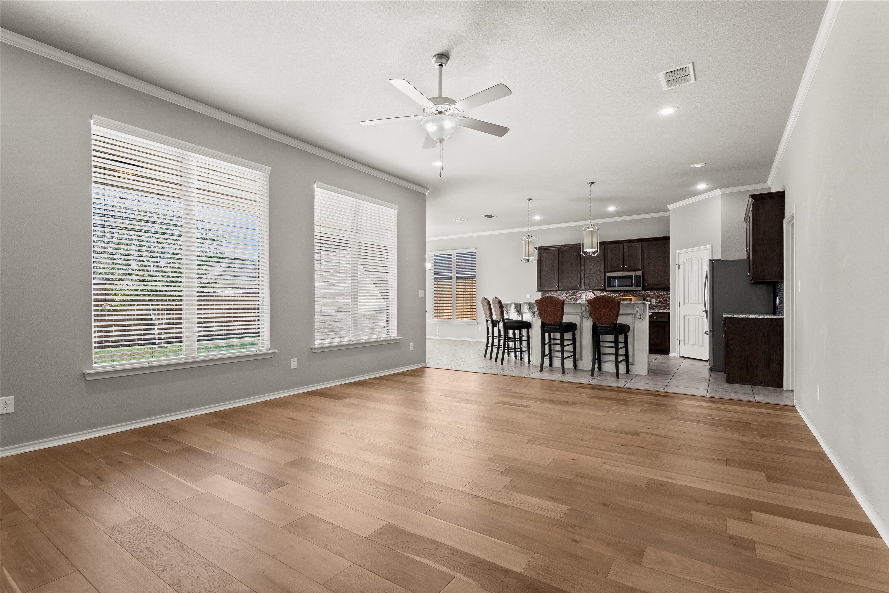 9616 Kline Avenue Lubbock, TX 79424 - Photo 7 of 33 a view of a kitchen with furniture and wooden floor