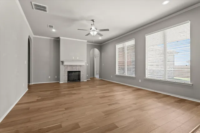 wooden floor in an empty room with a fireplace
