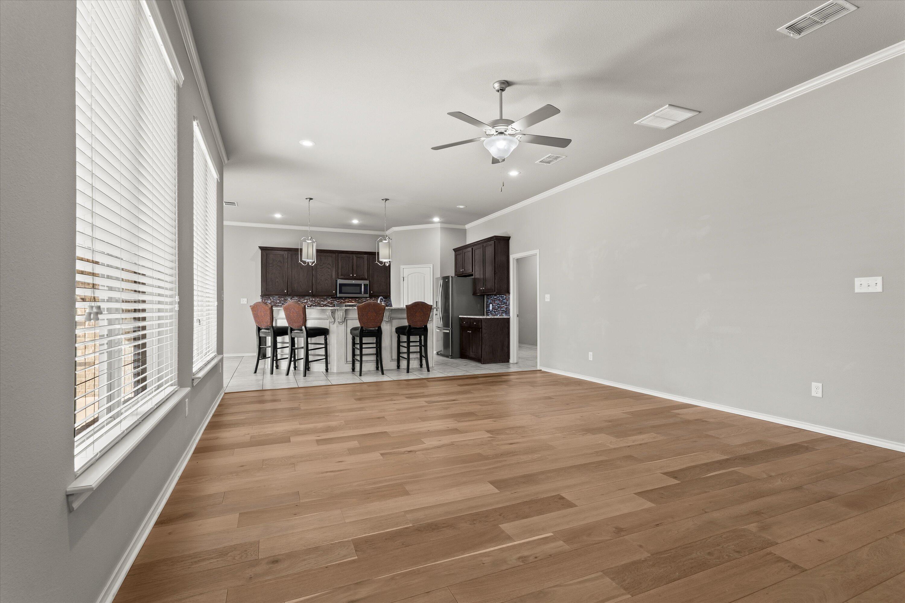 9616 Kline Avenue Lubbock, TX 79424 - Photo 10 of 33 a view of kitchen with furniture and wooden floor
