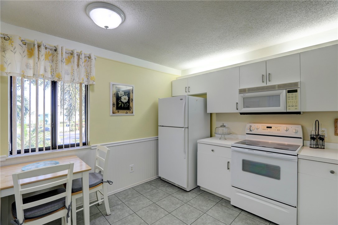 9635 Riverside Drive, Unit 4 Sebastian, FL 32958 - Photo 12 of 34 a kitchen with a stove and a refrigerator